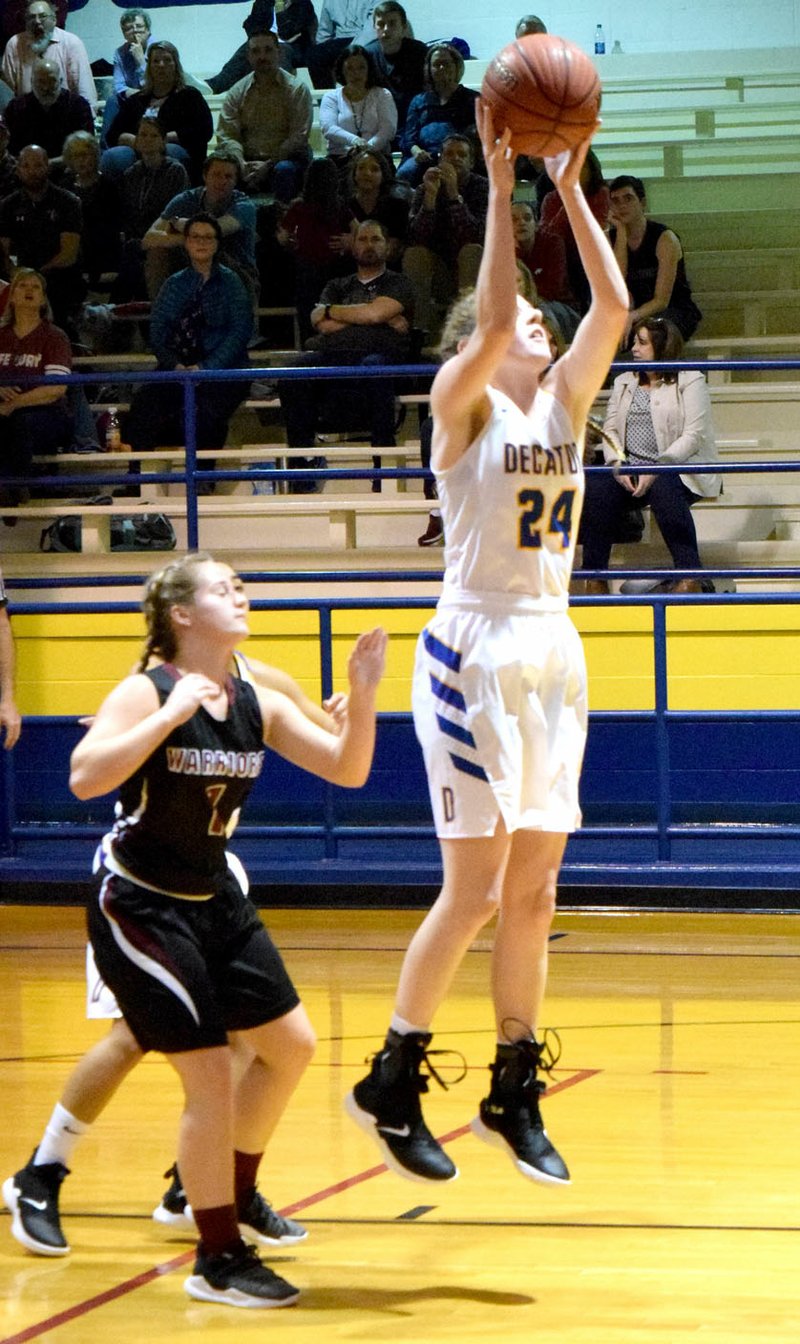 Westside Eagle Observer/MIKE ECKELS Sammie Skaggs (Decatur 21) pulls down a rebound during the second quarter of the Decatur-Life Way non-conference basketball game at Peterson Gym in Decatur Feb. 5. Skaggs, in the final home appearance of her high school career, lead the Lady Bulldogs to victory with 24 points over the Lady Warriors.