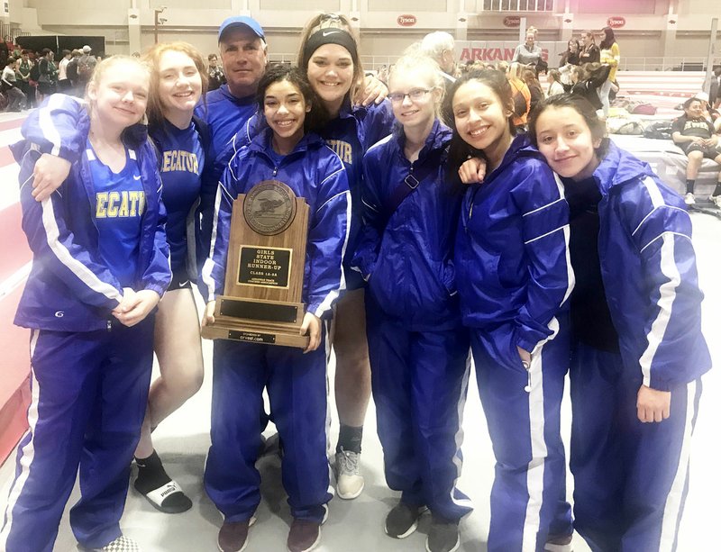 Westside Eagle Observer/SUBMITTED Members of the Decatur Lady Bulldog track team display their trophy after placing second in the 1A-2A division of the Arkansas Indoor High School Championship track meet at the Randal Tyson Track facility in Fayetteville Feb. 1. Track team members participating in the event included Olivia Verser (left), Bronwyn Brown, Coach Shane Holland, Desi Meek, Kyleigh McBride, Lizzie Haisman, Heidi Rubi and Deysi Rubi.