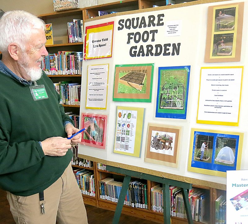 Westside Eagle Observer/SUSAN HOLLAND Burt Crume, of Gentry, examines a display with information about Square Foot Gardening, at the seed swap held at the Gravette Public Library Saturday, Feb. 9. Crume was one of four members of the Benton County Master Gardeners who was on hand to provide information and answer questions from gardeners who attended the event.
