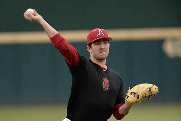 Arkansas pitcher Connor Noland warms up Friday, Jan. 25, 2019, during practice at Baum Stadium in Fayetteville.