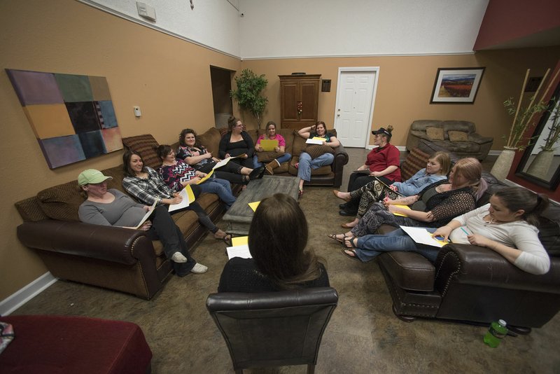File Photo/J.T. WAMPLER Program therapist Kate Siegenthaler conducts a weekly group session at Havenwood in Bentonville. Havenwood provides transitional housing for single mothers.