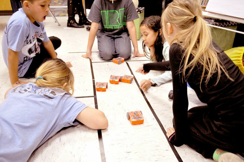 RACHEL DICKERSON/MCDONALD COUNTY PRESS Students in Bethany Hall's third-grade classroom at White Rock Elementary School work with Edison robots that Hall purchased through a grant from the McDonald County Schools Foundation.