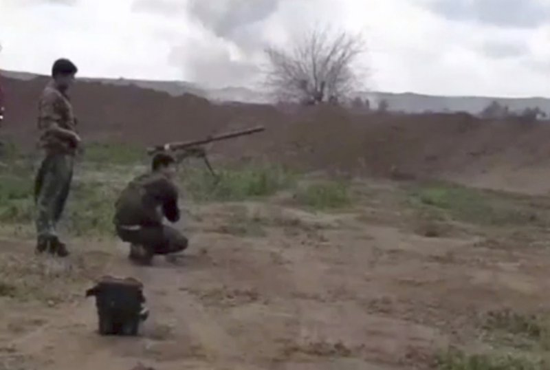 This frame grab from video provided on Tuesday, Feb. 12, 2019, by the Syrian Observatory for Human Rights, an opposition group, that is consistent with independent AP reporting, shows U.S.-backed Syrian Democratic Forces fighters take their position during a battle against Islamic State group militants, in the village of Baghouz, Deir El-Zour, eastern Syria.(Syrian Observatory for Human Rights via AP)