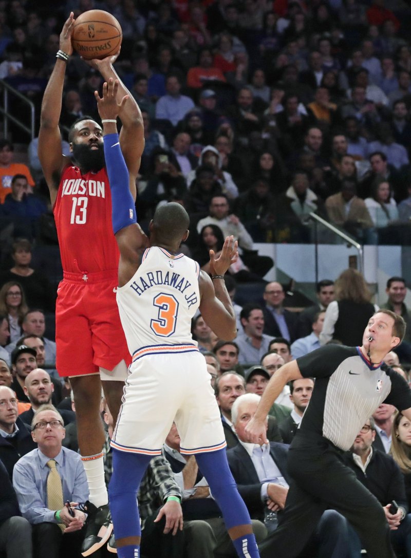 STEP BACK: Houston Rockets' James Harden (13) shoots over New York Knicks' Tim Hardaway Jr. (3) during the first half of a Jan. 23 game in New York. Harden, a seven-time All-Star, league MVP and scoring champion last season, has scored 30 or more points in 30 straight games, third-longest streak ever, and averaging 36.5 points per game is poised to win another scoring title in a runaway. He said he turned to the step-back 3 as a way to evolve with a game that has seen more than 2,500 step-back 3s taken already this season, after there were only 584 for all of 2014-15, according to NBAsavant.com.