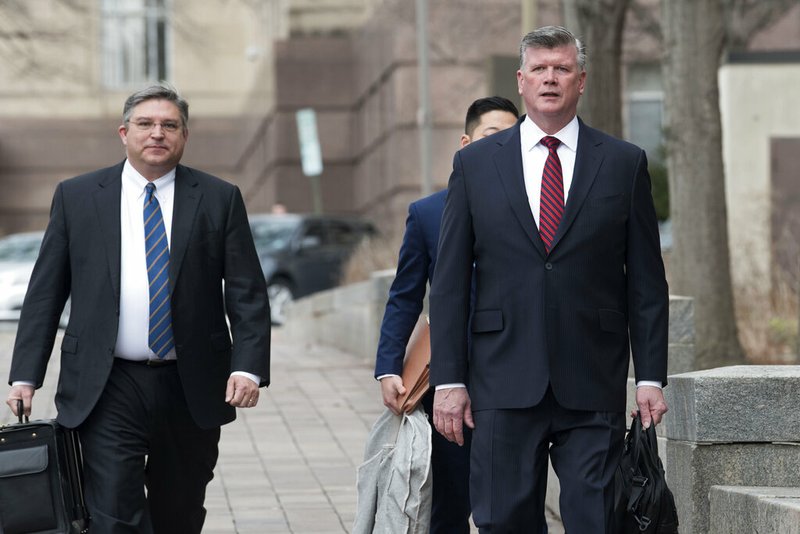 Members of the defense team for Paul Manafort, from left, Richard Westling, Tim Wang and Kevin Downing, walk to federal court Wednesday, Feb. 13, 2019, in Washington. (AP Photo/Kevin Wolf)