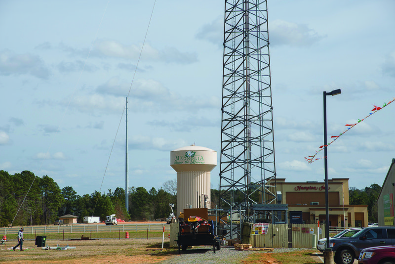 An April 18 hearing in Columbia County civil court has been scheduled in an ongoing legal battle over the construction of a new cell tower on city property along Hwy. 79 N. Pictured in the foreground (right) is an SBA Structures-owned T-Mobile tower, while the rival BRT Group monopole tower has been erected in the background, next to a Magnolia water tower.