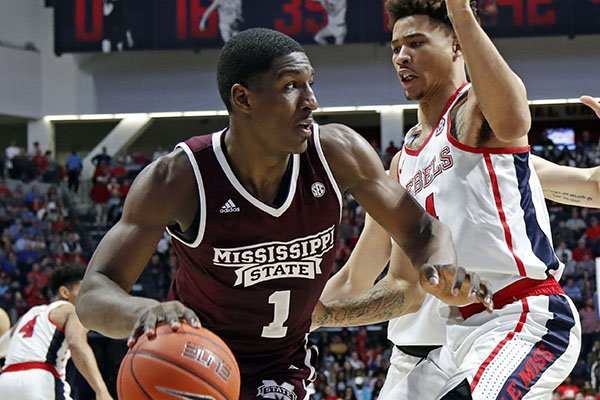 Mississippi State forward Reggie Perry (1) dribbles past Mississippi forward KJ Buffen (14) during the second half of an NCAA college basketball game in Oxford, Miss., Saturday, Feb. 2, 2019. Mississippi State won 81-75. (AP Photo/Rogelio V. Solis)

