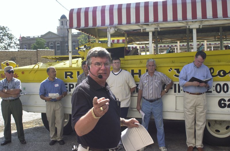 FILE — Tom Blackmon, president and auctioneer of Blackmon Auctions in Little Rock, looks for a bidder on Aug. 28, 2001, for one of six Land & Lakes Tour Boat Company's white and yellow "duck" boats in Hot Springs.