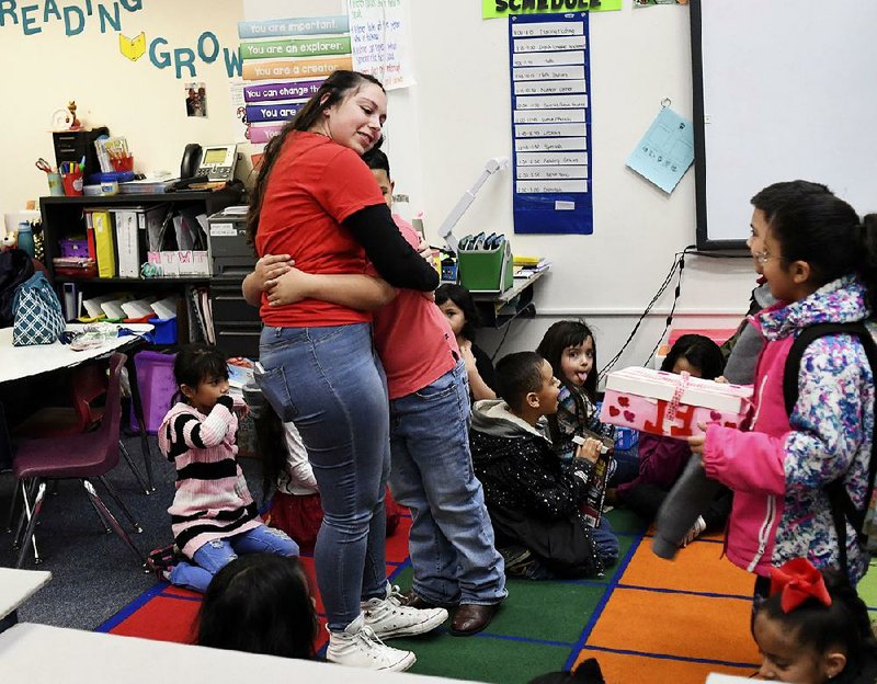 Hannah Maldonado, a first-grade teacher at Barnum Elementary, gets a hug from 7-year-old Jayden Gomez welcoming her back to class Thursday after Denver teachers ended a three-day strike. 