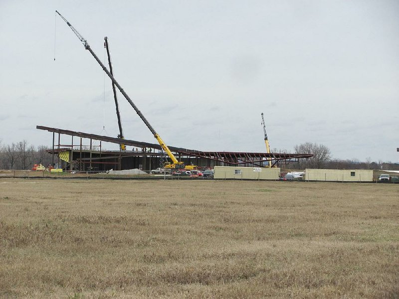 Construction crews work Thursday on the steel framing of the 50,000-square-foot U.S. Marshals Museum in Fort Smith. Officials have pushed back the opening date of the museum until next year. 