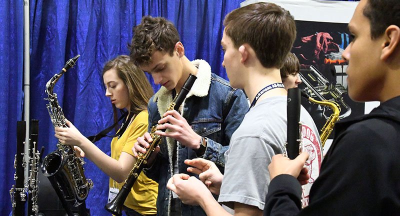 The Sentinel-Record/Grace Brown PUT TO THE TEST: Students from various Arkansas high schools look over instruments on display for testing at the Arkansas All-State Music Conference at the Hot Springs Convention Center on Thursday. The conference continues through Saturday with several free performances for the public to attend.