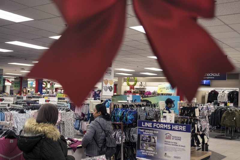 Shoppers stand in line to check-out at a Sears Holdings Corp. store on Black Friday at the Newport Centre Mall in Jersey City on Nov. 23, 2018. Bloomberg photo by Victor J. Blue.