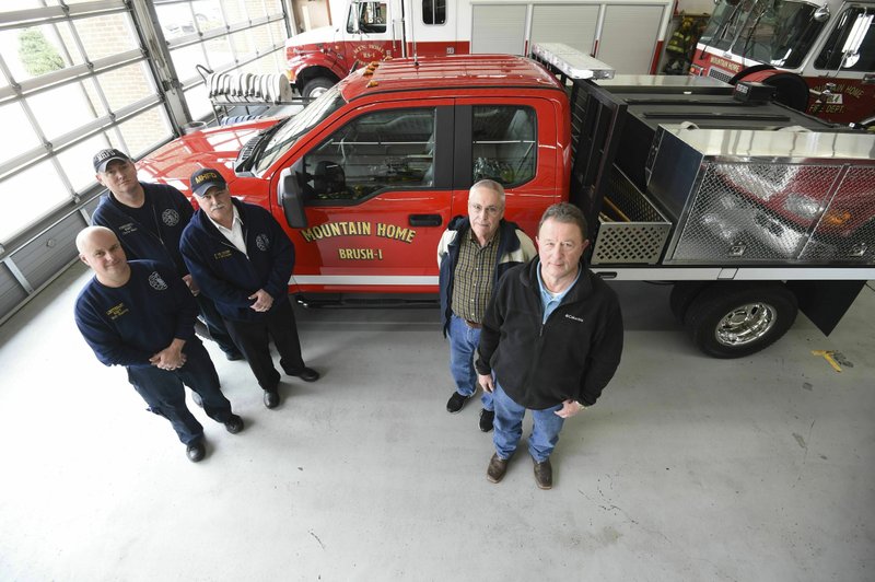 Mountain Home firefighters, from left, Chris Hall, Lt. Bob Harris and Chief Ken Williams were joined Friday by city council member Wayne Almond and Mayor Hillrey Adams at Station 1 as the city officials checked out the departments new brush truck Feb. 8 in Mountain Home. The town now owns a brush truck, thanks in part due to the recently instituted Public Safety Tax and the Mountain Home Rural Fire Protection District. The truck is a brand new 2019 Ford F350 extended cab truck with custom outfitting by WildFire out of Alvarado, Texas. The truck is four wheel drive and has a 300-gallon tank fitted to the one ton chassis. (Josh Dooley/The Baxter Bulletin via AP)

