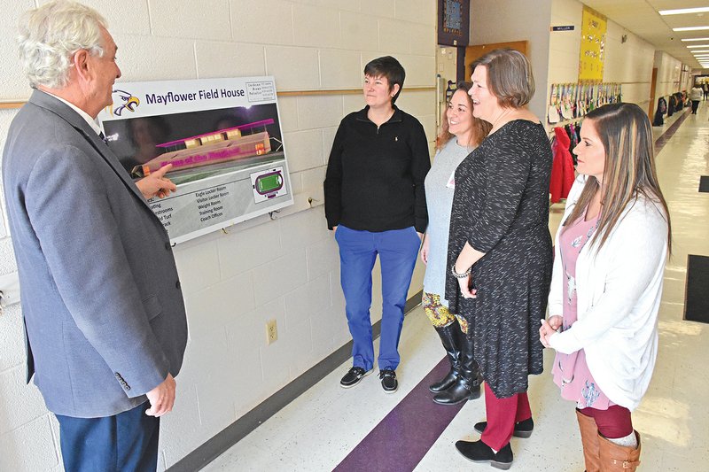 Mayflower Superintendent John Gray, from left; Neely Claassen, assistant elementary principal; Kara Colvin, a third-grade teacher; Lynn Rainey, literacy coach; and Whitney Cox, also a third-grade teacher, look at an architectural rendering of the proposed field house and improvements to the football field and track. During a special election Tuesday, voters in the district approved extending a debt-service millage to fund the $5 million project.