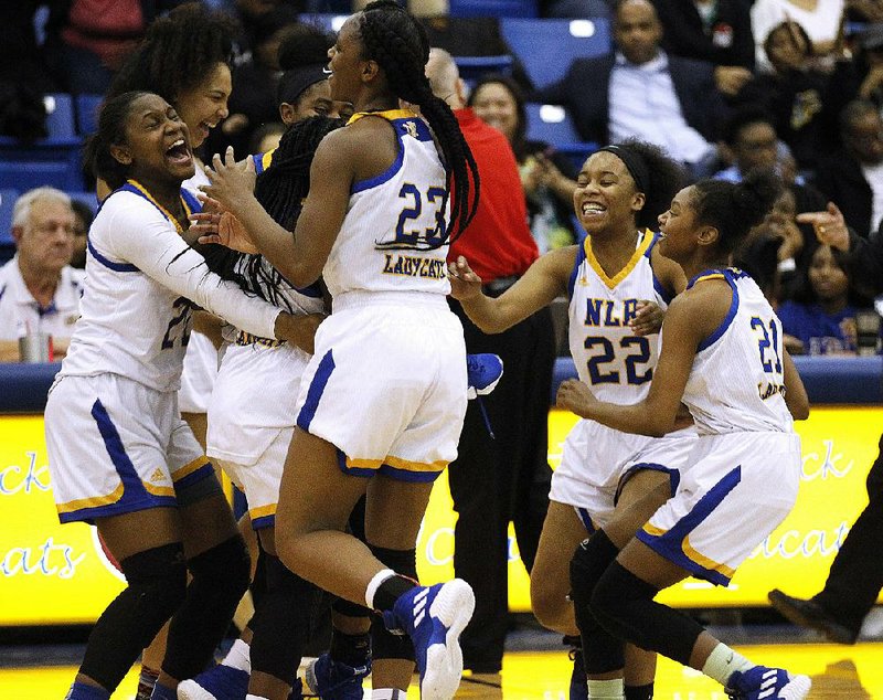 North Little Rock players celebrate after the No. 7 Lady Charging Wildcats’ 70-64 overtime victory in over top-ranked and previously unbeaten Fort Smith Northside on Friday night in North Little Rock. Senior Jordyn Neal had 19 points, 6 rebounds, 4 assists and 3 steals to lead the Lady Charging Wildcats.