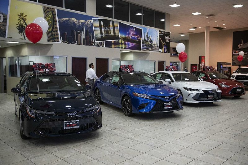 Toyota sedans are displayed at a dealership in Industry, Calif. If 25 percent tariffs are fully assessed against imported parts and vehicles, the price of imported vehicles would rise more than 17 percent, or around $5,000 each, according to forecasts from IHS Markit. 