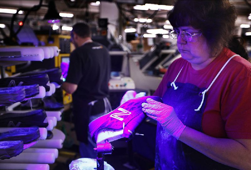 A worker assembles athletic shoes at a New Balance factory in Norridgewock, Maine. U.S. factory production contracted in January, mostly because of weakness in the automotive sector. 