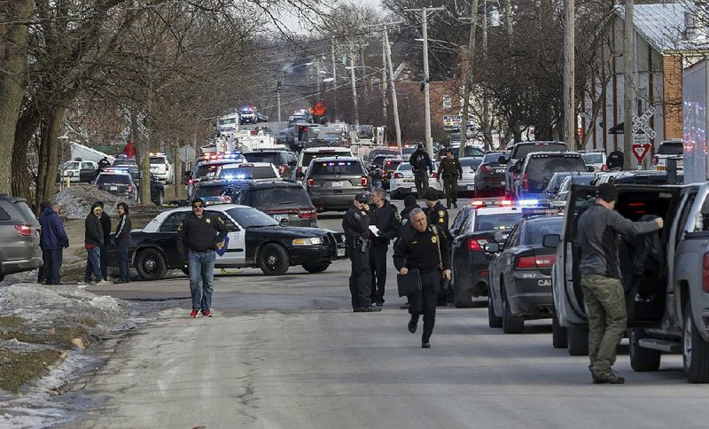 Police block the street near the industrial valve plant in Aurora, Ill., where the shooting occurred Friday. Aurora Police Chief Kristen Ziman said officers responded quickly and were fired upon as soon as they entered the building. 