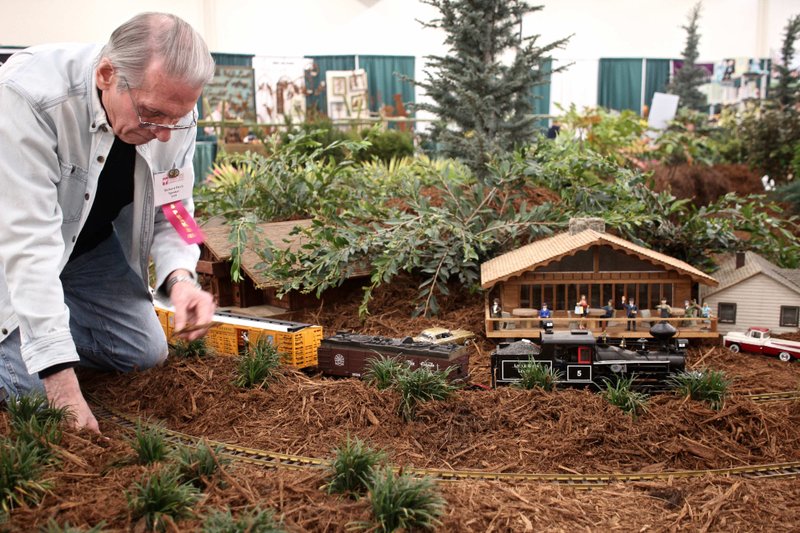 Richard Davis keeps his trains running smoothly in the Central Arkansas Model Railroad Club display March 3 during the 2018 Arkansas Flower and Garden Show on the Arkansas State Fairgrounds. Photo by Celia Storey