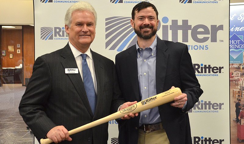 Submitted photo BATTER UP: Alan Morse, president of Ritter Communications, which is investing $7 million to bring increased broadband services to Hot Springs, gives a Louisville commemorative bat to Paul Lynch, vice chairman of the Hot Springs Advertising and Promotion Commission, after pledging a $50,000 donation to the ad commission's Majestic Park baseball field restoration project. Photo courtesy of Mara Kuhn, with The Greater Hot Springs Chamber of Commerce.