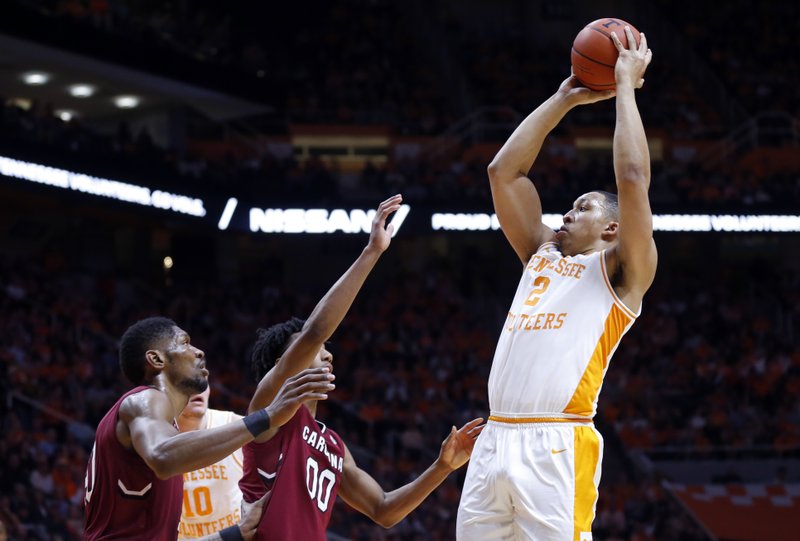 Tennessee forward Grant Williams (2) shoots over South Carolina guard A.J. Lawson (00) and forward Chris Silva (30) during the second half of an NCAA college basketball game Wednesday, Feb. 13, 2019, in Knoxville, Tenn. Tennessee won 85-73. (AP photo/Wade Payne)