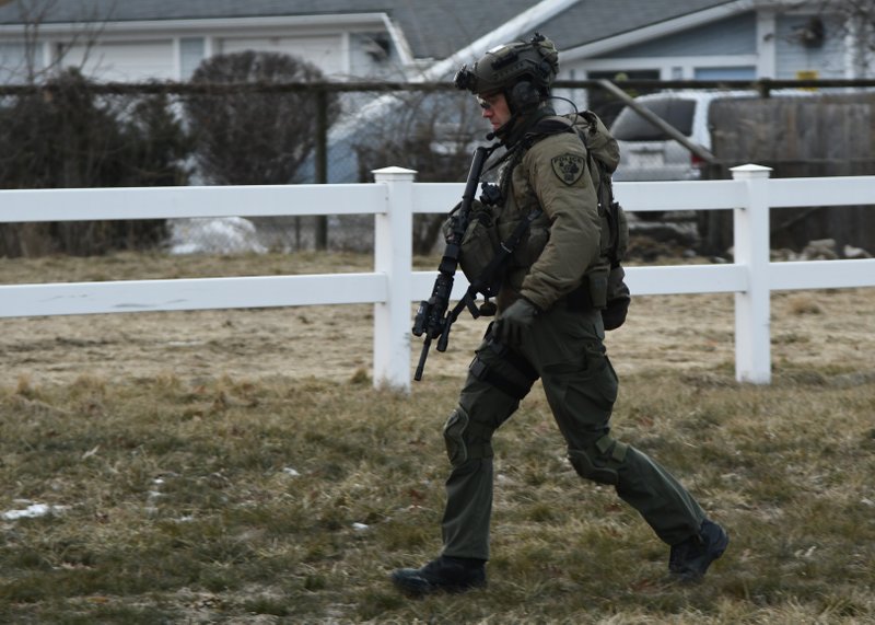 A law enforcement officer works at the scene of a shooting at the Henry Pratt Co. on Friday, Feb. 15, 2019, in Aurora, Ill. Officials say several people were killed and at least five police officers were wounded after a gunman opened fire in an industrial park. (AP Photo/Matt Marton)