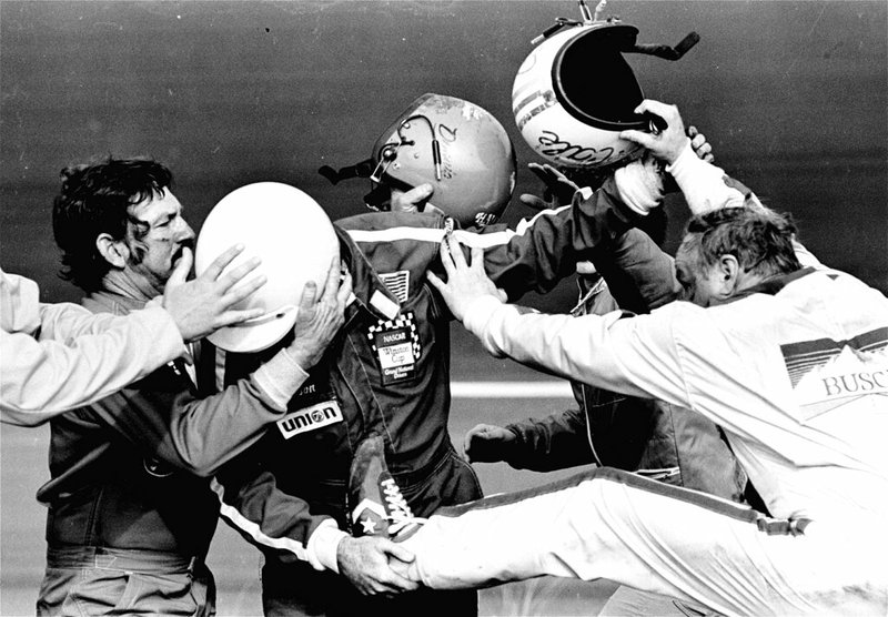 In this Feb. 18, 1979, file photo, Cale Yarborough, right, kicks and pushes Bobby Allison, center, who is catching his leg as brother Donnie, left, tries to pull his Bobby free from the fight which started after Yarborough collided with Donnie on the last lap of the Daytona 500 auto race, taking them both out of the finals in the race in Daytona Beach, Fla. The 1979 race was instrumental in broadening NASCAR's southern roots. Forty years later, it still resonates as one of the most important days in NASCAR history. (AP Photo/Ric Feld, File)