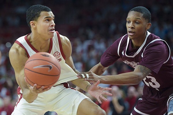 Arkansas guard Jalen Harris (5) looks for an opening as Mississippi State guard Tyson Carter (23) defends during a game, Saturday, Feb. 16, 2019, at Bud Walton Arena in Fayetteville. 