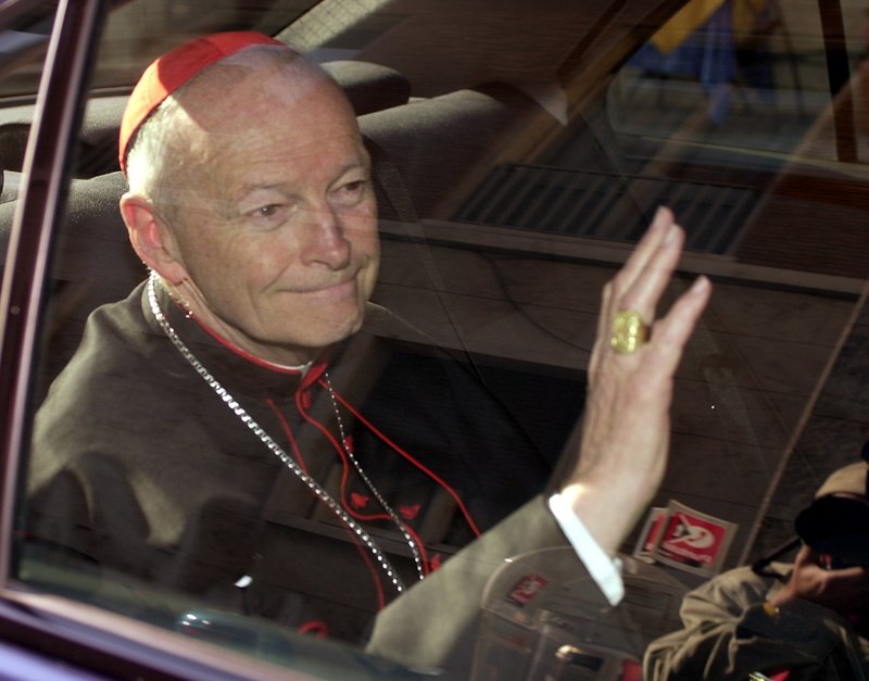 In this April 2002 file photo Cardinal Theodore McCarrick of the Archdiocese of Washington, waves as he arrives at the Vatican in a limousine. On Saturday, the Vatican announced Pope Francis defrocked former U.S. Cardinal Theodore McCarrick after Vatican officials found him guilty of soliciting for sex while hearing Confession. (AP Photo/Andrew Medichini, file)


