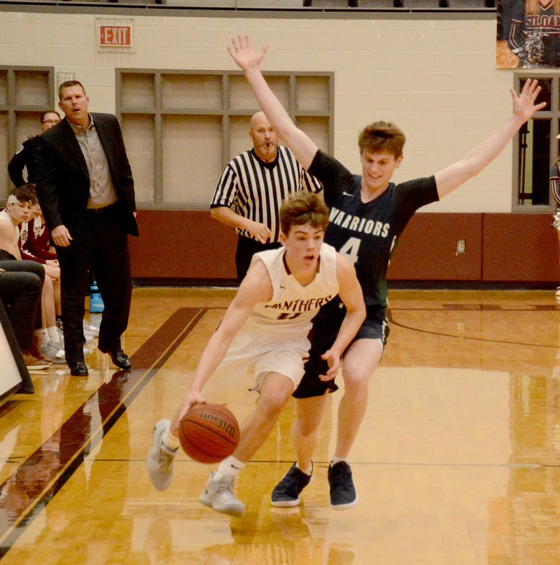 Graham Thomas/Siloam Sunday Siloam Springs junior guard Evan Sauer brings the ball up the floor as Little Rock Christian's Luke Grawer defends during Friday's game at Panther Activity Center. Siloam Springs defeated Little Rock Christian 66-52.