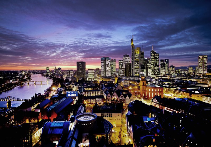 AP/MICHAEL PROBST The sun sets over Frankfurt, Germany, with the Main river at left earlier this month. Germany is a eurozone member. 