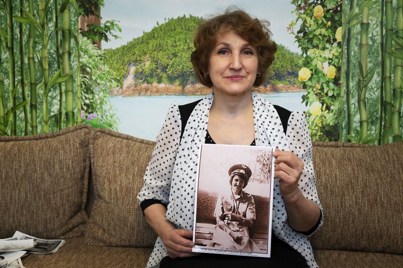 Tatyana Rybalchenko shows a photo from her days as a wartime nurse in Afghanistan. 