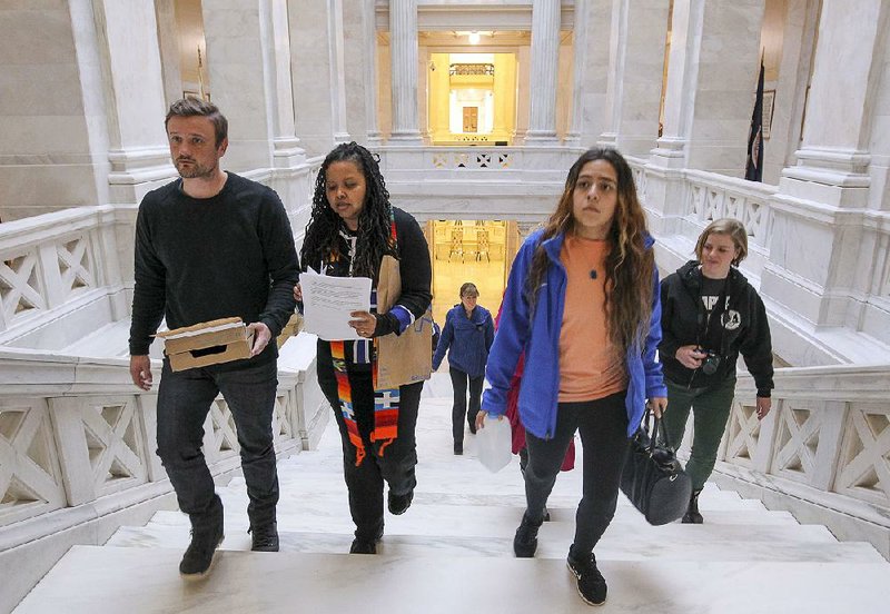Solomon Burchfield, left, Anika Whitfield, Maria Meneses and other members of the grassroots group Arkansas Poor People's Campaing: A National Call for Moral Revival, deliver a letter of moral demands to Gov. Asa Hutchinson's office after a rally at the State Capitol on Monday. The group claims they represent Arkansas's poor and disenfranchised and are prepared to engage in non-violent civil disobedience if legislators ignore the poor in political decisions.