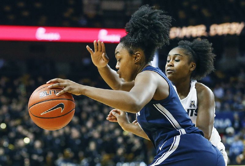 Former Central Arkansas Christian star Christyn Williams of Connecticut drives past Central Florida guard Korneila Wright during the first quarter Sunday in Orlando, Fla. Williams had 12 points as Connecticut won 78-41.