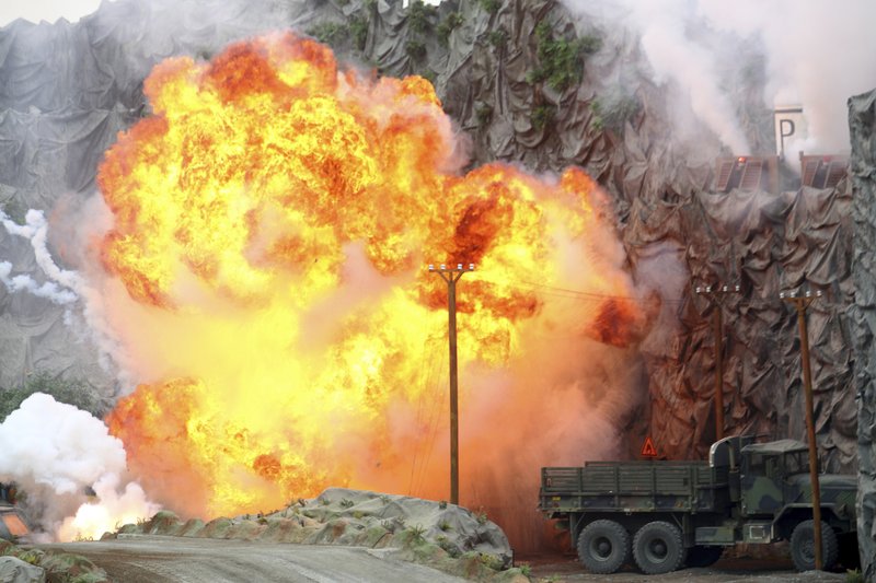 An explosion strikes during a military demonstration targeting a theatrical &quot;ballistic missile launchpad&quot; at the International Defense Exhibition and Conference in Abu Dhabi, United Arab Emirates, Sunday, Feb. 17, 2019. The biennial arms show in Abu Dhabi comes as the United Arab Emirates faces increasing criticism for its role in the yearlong war in Yemen. (AP Photo/Jon Gambrell)