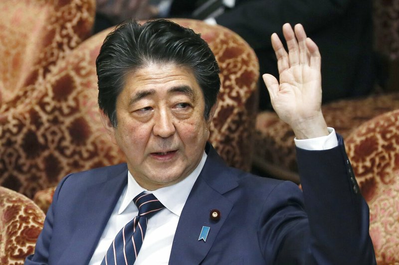 Japanese Prime Minister Shinzo Abe raises his hand during a parliamentary session at the Lower House in Tokyo, Monday, Feb. 18, 2019. Abe and his chief spokesman have declined to say if Abe nominated President Donald Trump for a Nobel Peace prize. Speaking in parliament on Monday, Abe said the Nobel committee has never in a half-century disclosed the identity of the person or groups behind such nominations. He said, "I thus decline comment."(Kyodo News via AP)