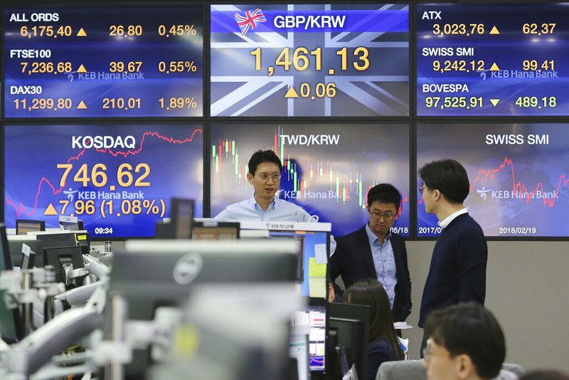 Currency traders work at the foreign exchange dealing room of the KEB Hana Bank headquarters in Seoul, South Korea, Monday, Feb. 18, 2019. Asian markets were broadly higher on Monday as traders looked forward to the continuation of trade talks between Chinese and American officials in Washington this week. (AP Photo/Ahn Young-joon)