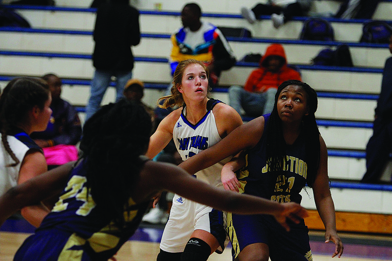 Junction City's Keaundra Jackson blocks out Parkers Chapel's Drue Thomas in action this season. The Lady Dragons will play Mt. Ida Thursday at 7 p.m. in the 2A-South Regional in Junction City. The Lady Trojans will play Cossatot River on Wednesday at 7 p.m.