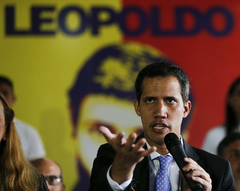 Juan Guaido, Venezuela’s self-proclaimed interim president, speaks during a news conference at the Voluntad Popular Party head- quarters Monday in Caracas, Venezuela. 