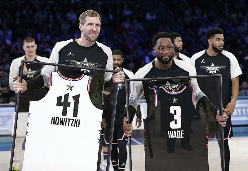 Dirk Nowitzki of the Dallas Mavericks (left) and Dwyane Wade of the Miami Heat are given jerseys during the second half of Sunday’s NBA All-Star Game. Wade has announced he is retiring at the end of the season.
