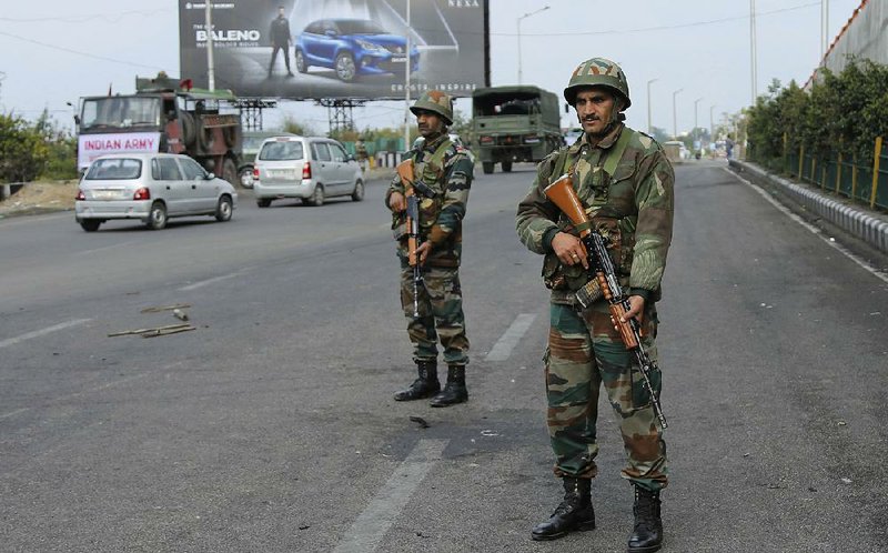 Indian soldiers keep vigil during the fourth consecutive day of curfew in Jammu, the winter capital of Jammu and Kashmir state, India, on Monday. 