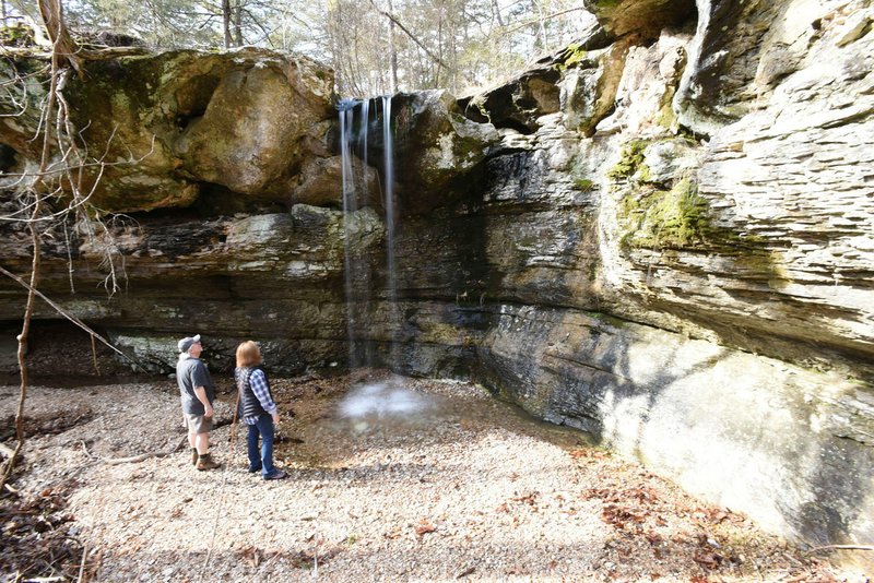 NWA Democrat-Gazette/FLIP PUTTHOFF Dennis and Linda Heter gaze mid-January at a waterfall tucked away in the forest at the Madison County Wildlife Management Area. The 14,000 acre tract of public land administered by the Arkansas Game and Fish Commission is located between Huntsville and Eureka Springs.