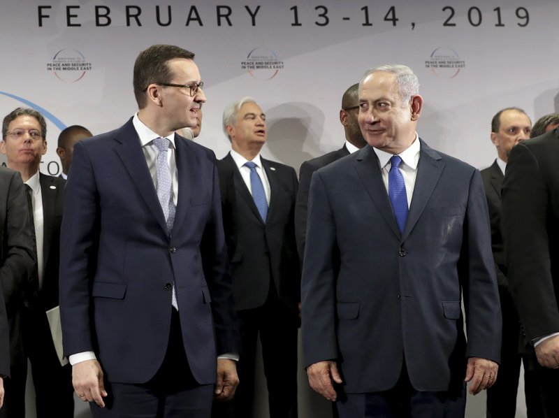 File -- In this Thursday, Feb. 14, 2019 photo Poland's Prime Minister Mateusz Morawiecki, left, and Israeli Prime Minister Benjamin Netanyahu, right, attend a group photo during a meeting in Warsaw, Poland. Poland's prime minister canceled plans for his country to send a delegation to meeting in Jerusalem on Monday after the acting Israeli foreign minister Israel Katz said that Poles &quot;collaborated with the Nazis&quot; and &quot;sucked anti-Semitism from their mothers' milk&quot;. (AP Photo/Michael Sohn)