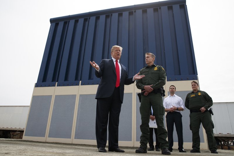 FILE - In this March 13, 2018, file photo, President Donald Trump talks with reporters as he reviews border wall prototypes in San Diego. California's attorney general filed a lawsuit Monday, Feb. 18, 2019, against Trump's emergency declaration to fund a wall on the U.S.-Mexico border. Xavier Becerra released a statement Monday saying 16 states — including California — allege the Trump administration's action violates the Constitution. (AP Photo/Evan Vucci, File)

