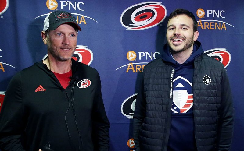 Tom Dundon (left), majority owner of the NHL’s Carolina Hurricanes, and Charlie Ebersol, co-founder and CEO of the Alliance of American Football, speak with members of the media Tuesday about Dundon’s $250 million investment in the AAF.