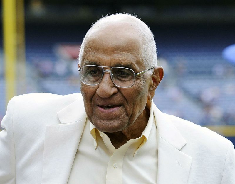 In this Aug. 18, 2012, file photo, former Dodgers pitcher Don Newcombe stands on the field at Turner Field, where he received the Beacon of Hope Award before the Civil Rights Game, in Atlanta.