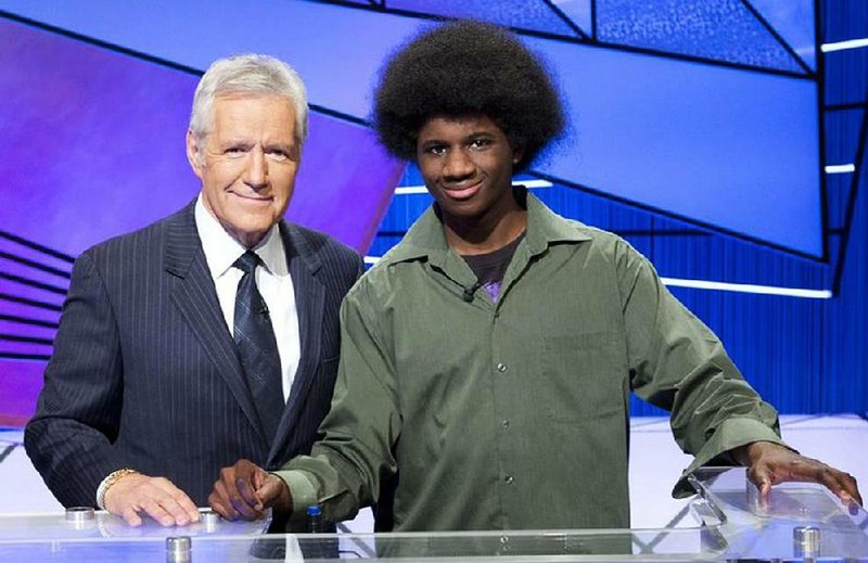 FILE — Leonard Cooper and "Jeopardy!" host Alex Trebek pose for a photo in 2012 on the show's set.