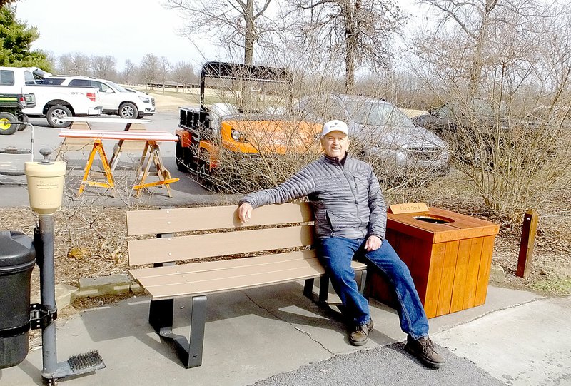 Lynn Atkins/The Weekly Vista Phil Spencer, president of the Friends of the Highlands volunteer group, demonstartes one of the refurbished benches his group is working on for the golf course.