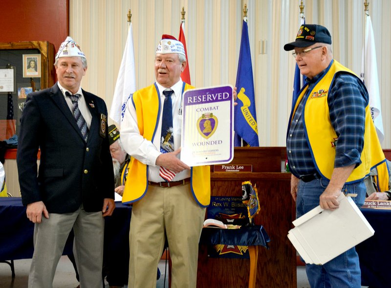 Janelle Jessen/Herald-Leader Veterans of Foreign Wars Post 1674 was proclaimed a Purple Heart Memorial Post during a ceremony on Feb. 12. The post was presented with a plaque and a reserved parking sign for Purple Heart veterans. Pictured, from left, are Chuck Adkins, commander of the Military Order of the Purple Heart Region V, Frank Lee, commander of VFW Post 1674, and Don Martin, a member of Post 1674 and Military Order of the Purple Heart Chapter 460.