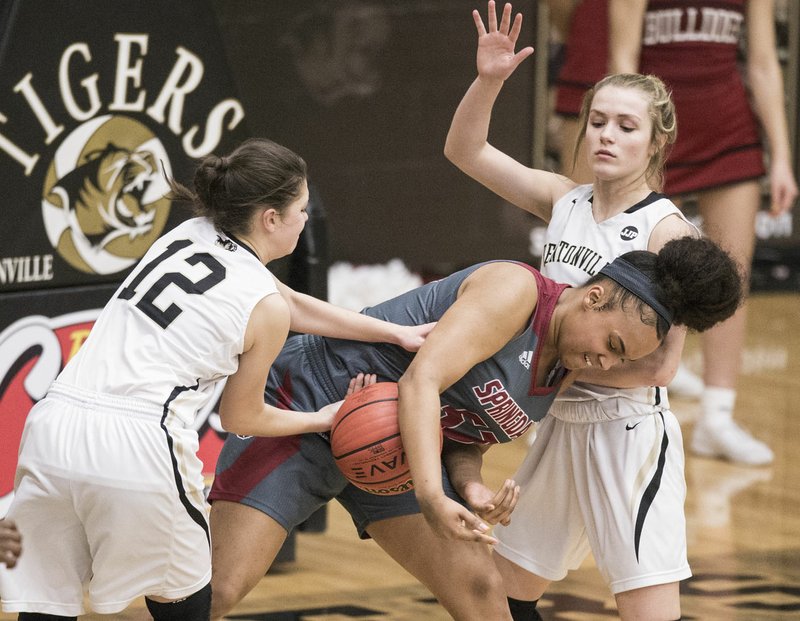 NWA Democrat-Gazette/BEN GOFF @NWABENGOFF Natalie Smith (left) and Heidi Baum of Bentonville try to steal from Nevaeh Griffin of Springdale Tuesday, Feb. 19, 2019, during the game in Bentonville's Tiger Arena.